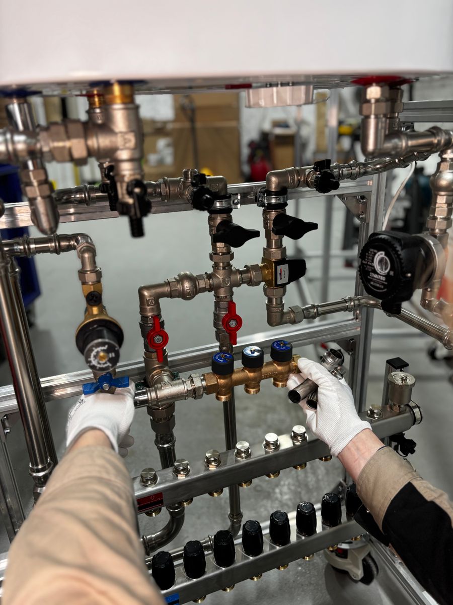 Technician adjusting refrigerant line valves