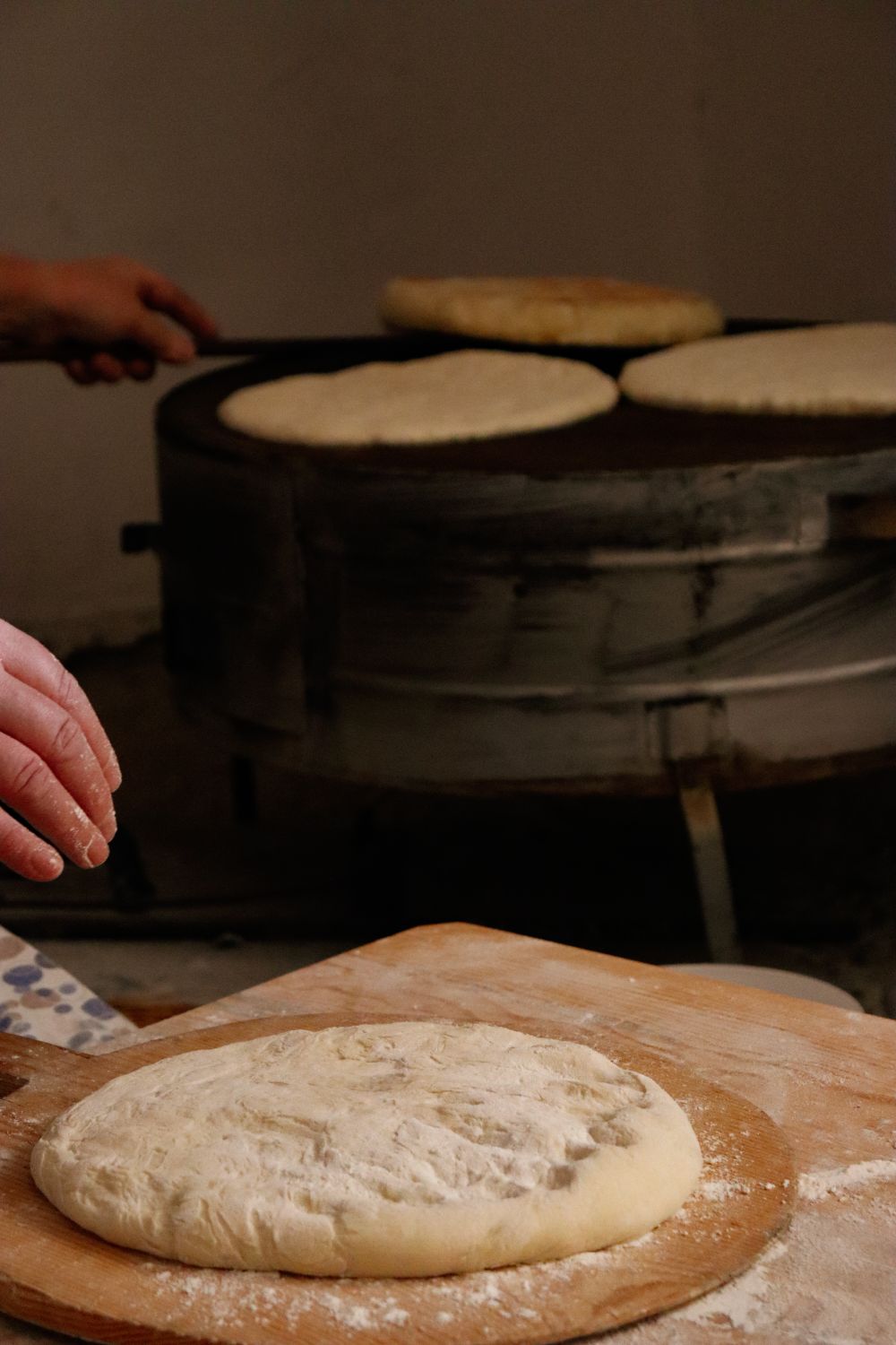 Hands shaping bread dough at Bakedsome