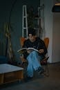 Young man reading in modern Berlin apartment