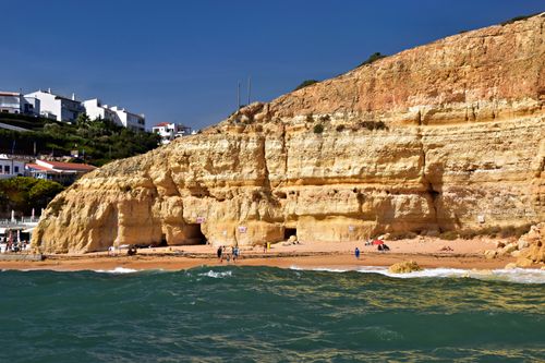 Free Sunny day at a beach with cliffs in Faro District, Portugal, showcasing natural beauty. Stock Photo