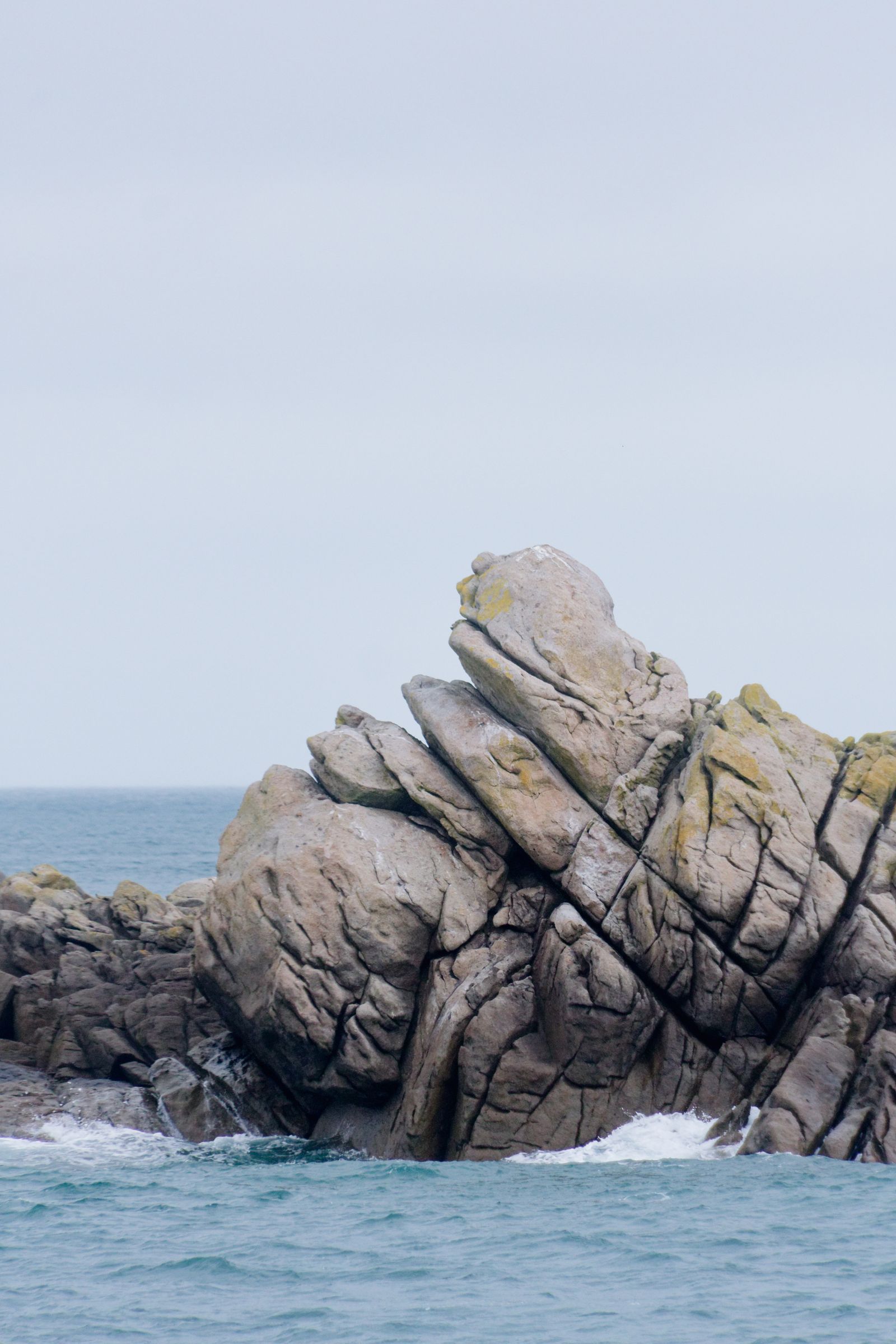 Majestic rock formation along the Normandie coast with ocean waves