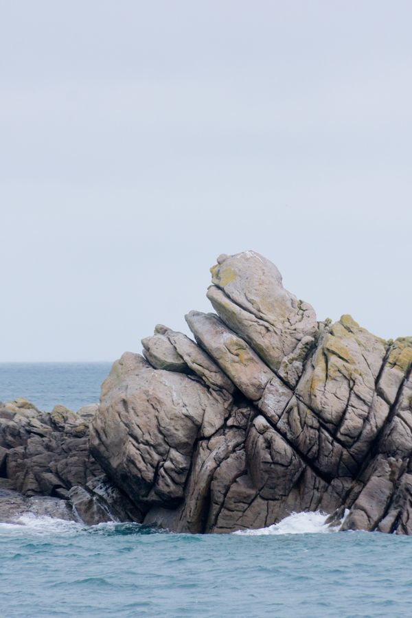 Majestic rock formation along the Normandie coast with ocean waves
