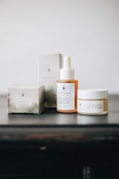 Artisan skincare products elegantly displayed with a minimalist aesthetic, featuring a serum and face balm.