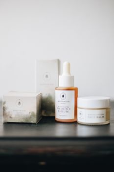 Elegant flat lay of artisan skincare products with vitamin C serum and face balm.