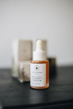 A sleek glass bottle of vitamin C serum with a dropper, perfect for a minimalist beauty routine.