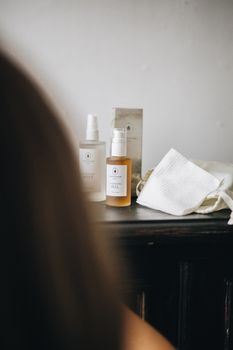 Explore a minimalist skincare setup featuring natural oil and serum bottles for a serene beauty ritual.
