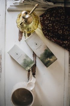 Artistic flat lay of beauty products and natural items on rustic surface.