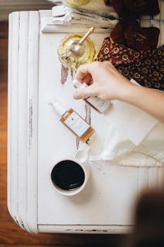 Flat lay of natural skincare products with coffee on rustic table, embodying a cozy morning routine.