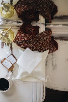 Handcrafted skincare products with cozy textiles in a warm, minimalist arrangement.