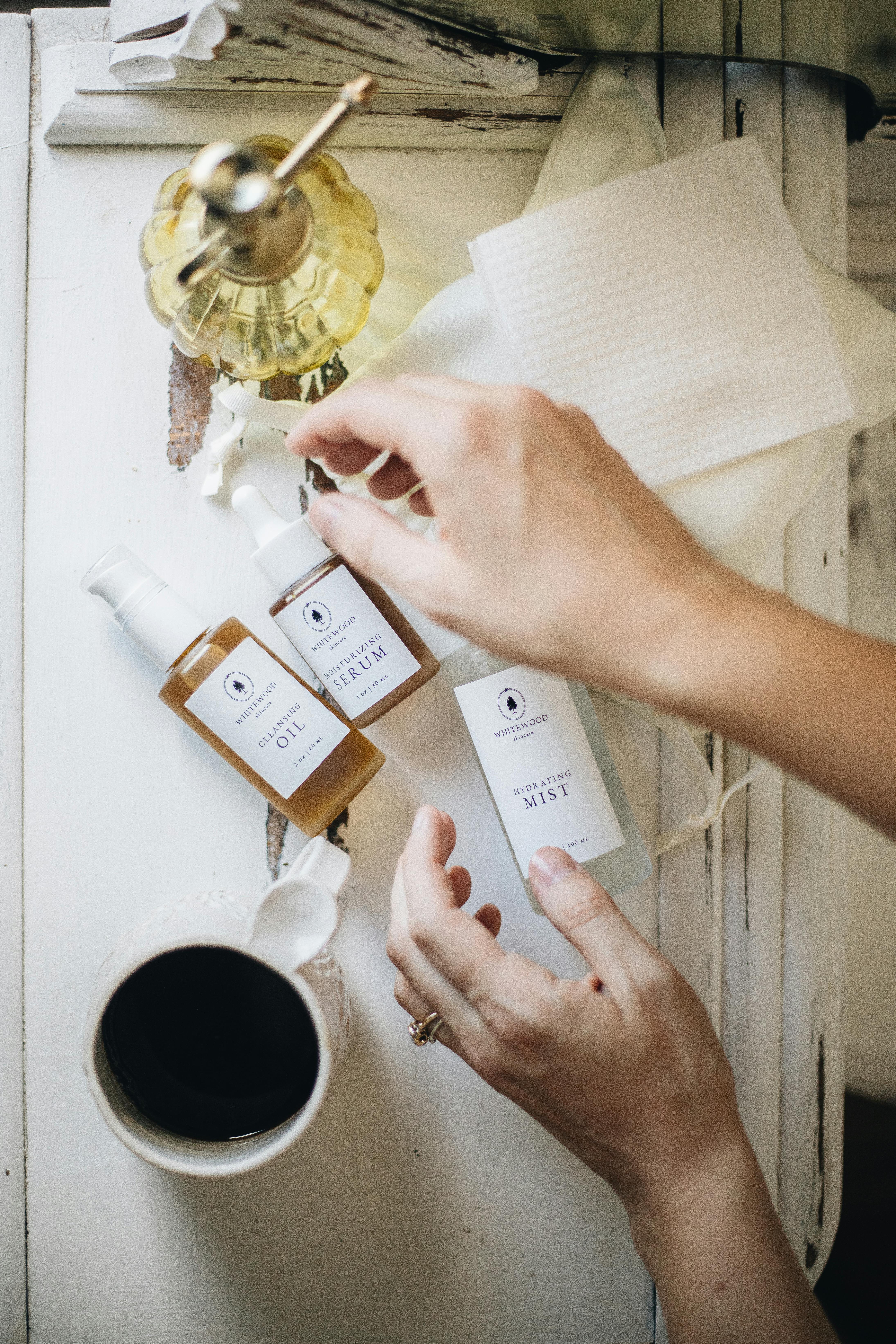 Flatlay of skincare products and coffee for a cozy morning routine.
