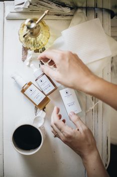 Flatlay of skincare products and coffee for a cozy morning routine.