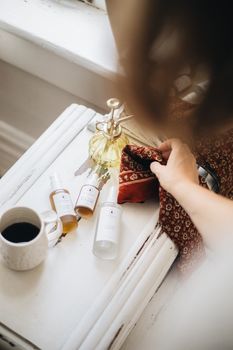 Flat lay of artisan skincare items and a coffee cup on a vintage table for a cozy aesthetic.