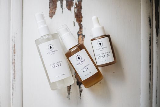 Elegant flatlay of natural skincare products on rustic wood background.