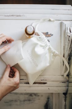 Natural skincare products and cloth on a rustic white wooden surface, evoking a minimalist and cozy aesthetic.