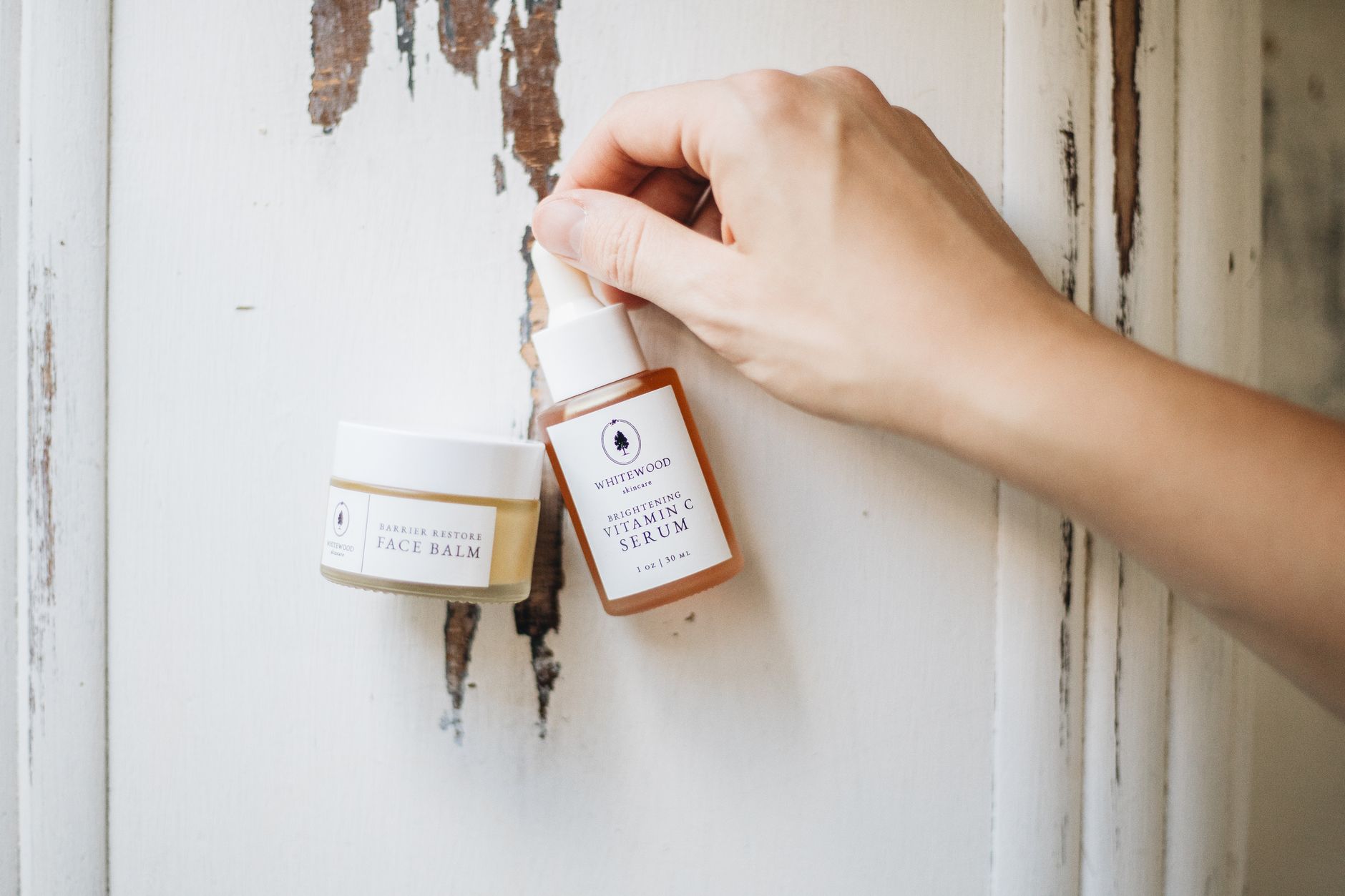 Elegant skincare display featuring face balm and vitamin C serum, showcasing minimalist beauty.