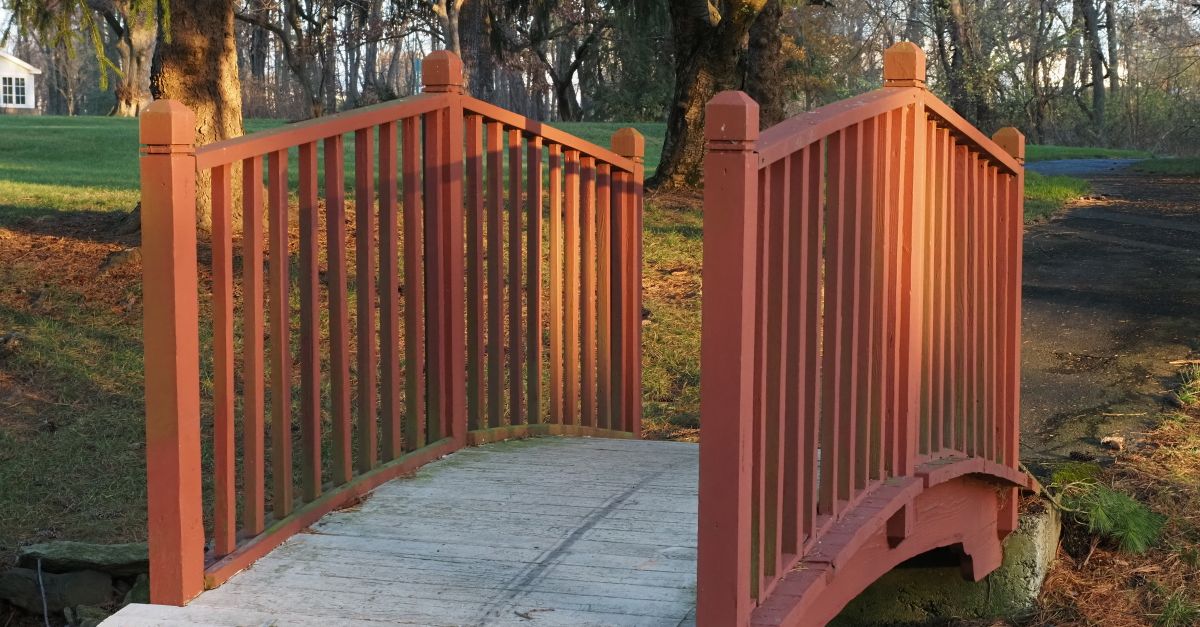 A charming wooden footbridge in a tranquil park setting during fall in Warrington, PA.