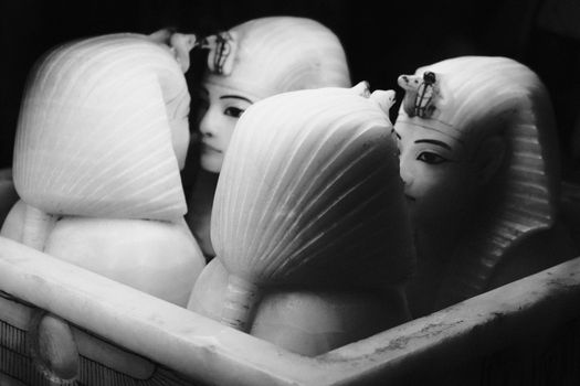 Black and white photo of Egyptian pharaoh busts, highlighting ancient artistry.