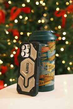 Stylish phone case and mug with festive Christmas background lights.