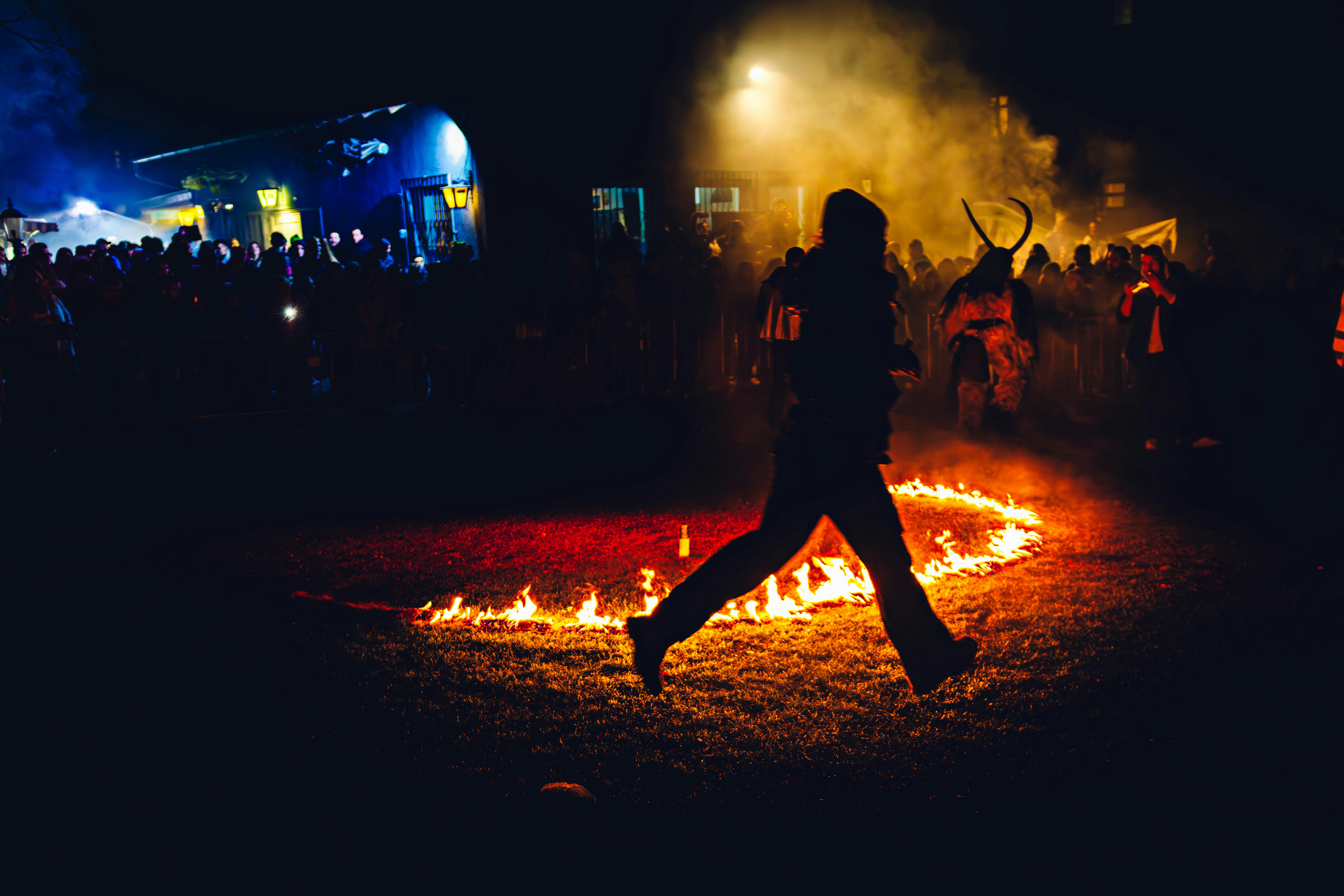 A vibrant scene from Vienna's Krampus festival showcasing fire dancing under the night sky.