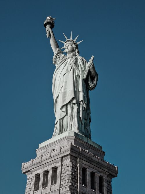 Free A striking view of the Statue of Liberty standing tall against a clear blue sky in New York City. Stock Photo