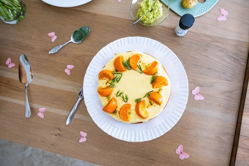 Free Top view of a beautifully garnished cheesecake with oranges and rosemary on a wooden table. Stock Photo