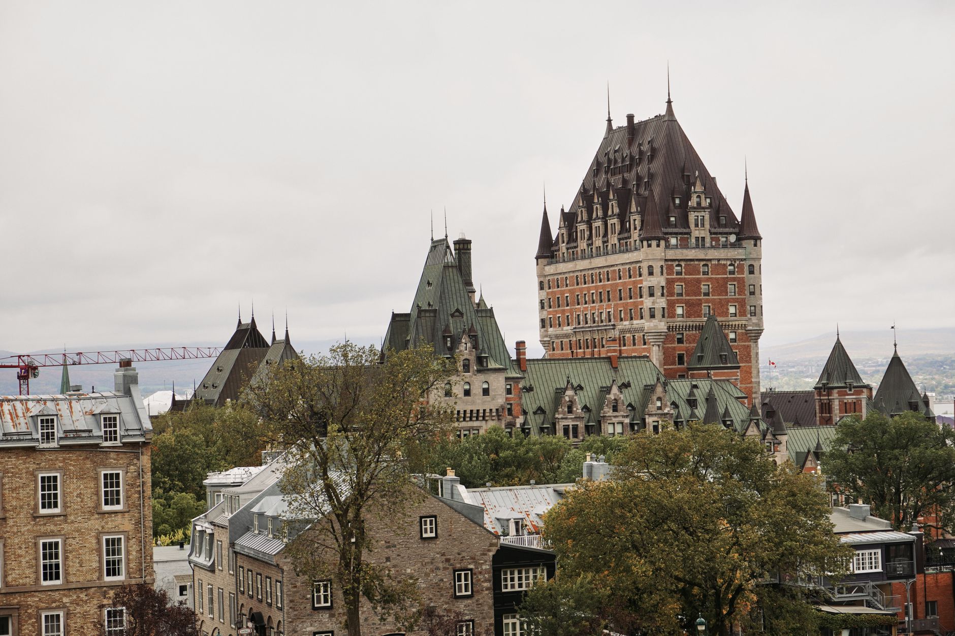 A scenic view of Château Frontenac in Québec City, showcasing historic architecture amidst a cloudy sky. Related image for Hospitality in Canada: The Practical Guide for Hotel Teams.