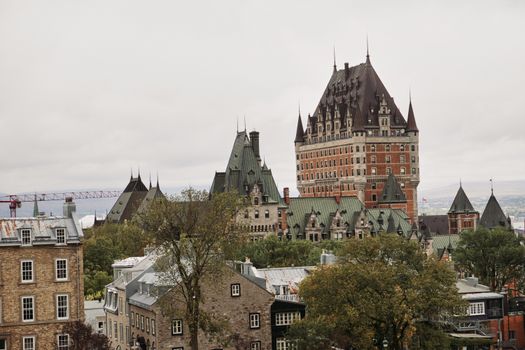 A scenic view of Château Frontenac in Québec City, showcasing historic architecture amidst a cloudy sky.