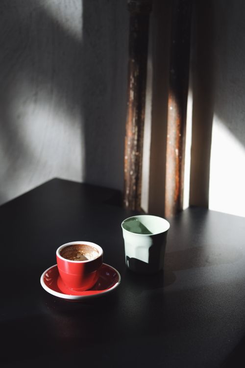 A moody espresso cup in a dark cafe