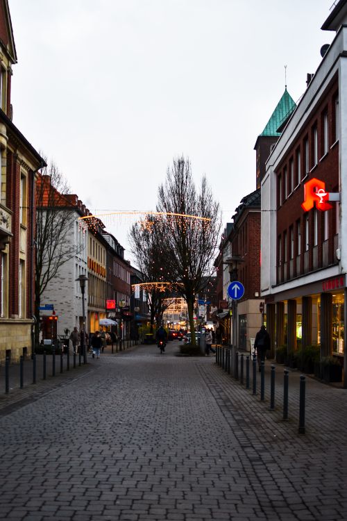 Free Evening view of a quaint city street adorned with festive lights, capturing a serene urban winter scene. Stock Photo