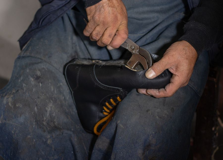 Hand tools being used on a heeled shoe