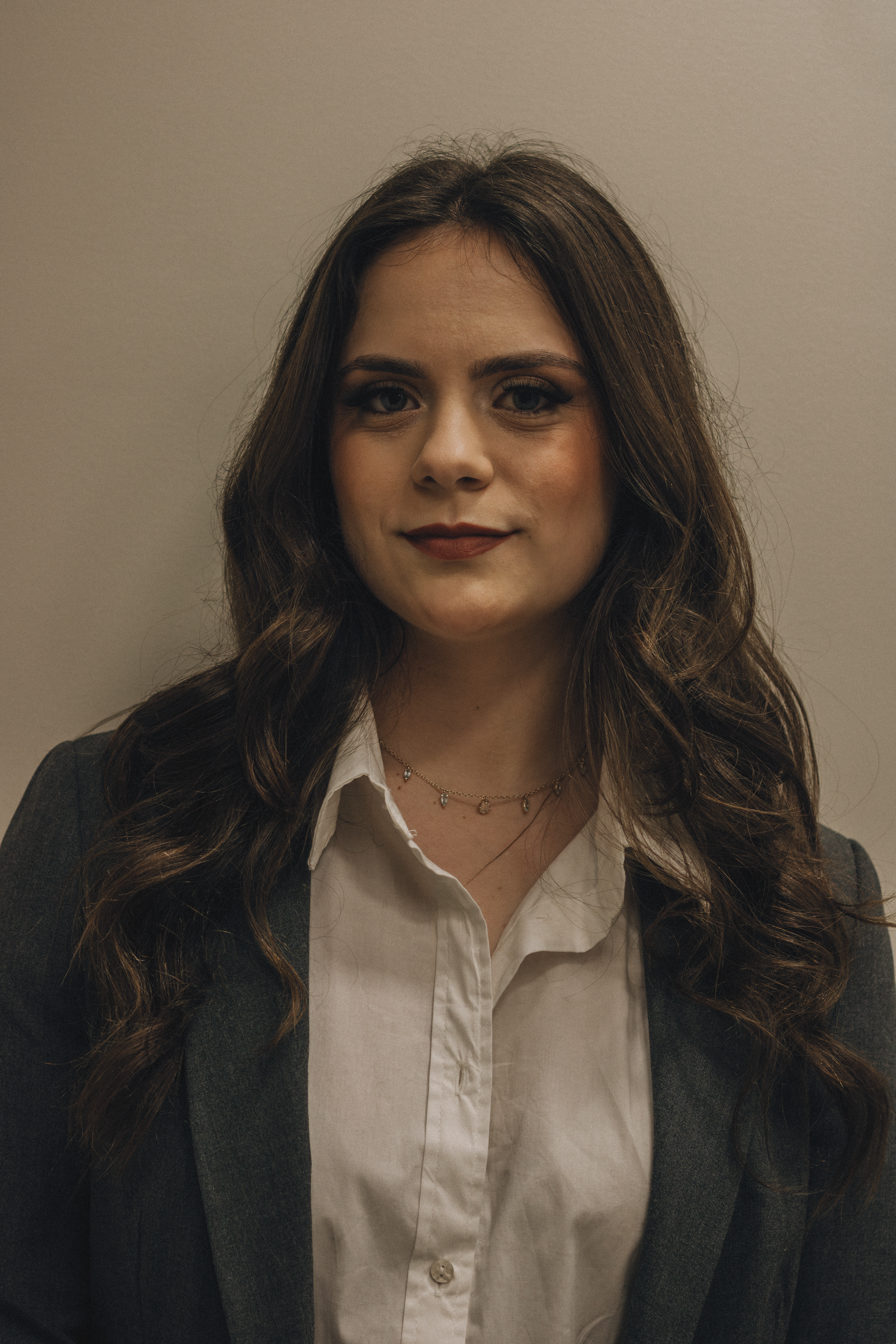Confident young woman wearing a suit, perfect for corporate and business themes.