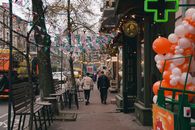 Charming Kyiv street decorated with flags and balloons, creating a lively atmosphere.