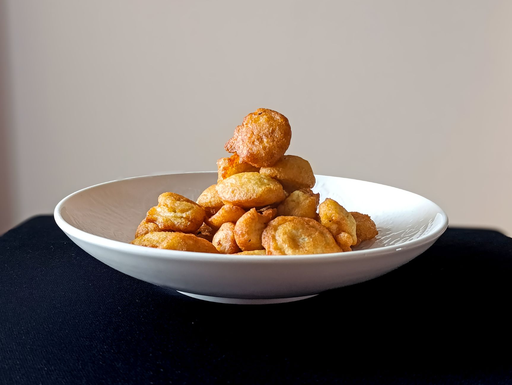 Ricotta fritters frying to golden perfection