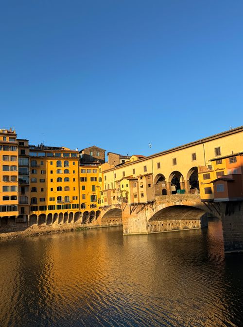 Free Stunning view of Ponte Vecchio and Arno River at sunset in Florence, Italy. Stock Photo