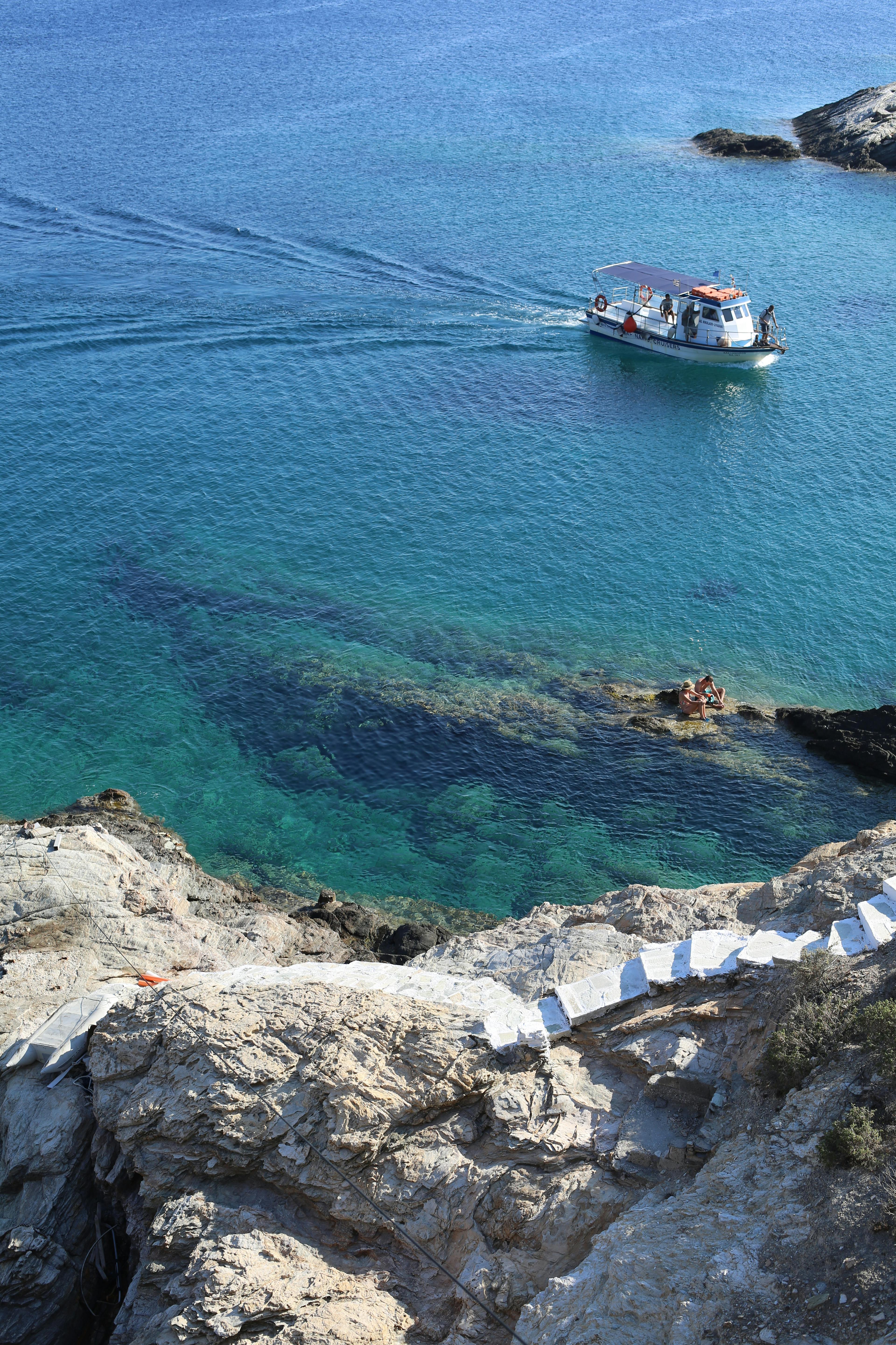 A beautiful coastal scene featuring a boat on clear blue water.