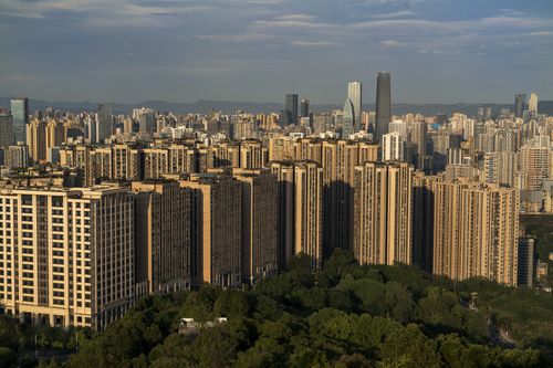 Free Aerial view of a bustling cityscape featuring modern high-rise residential and commercial buildings with greenery. Stock Photo