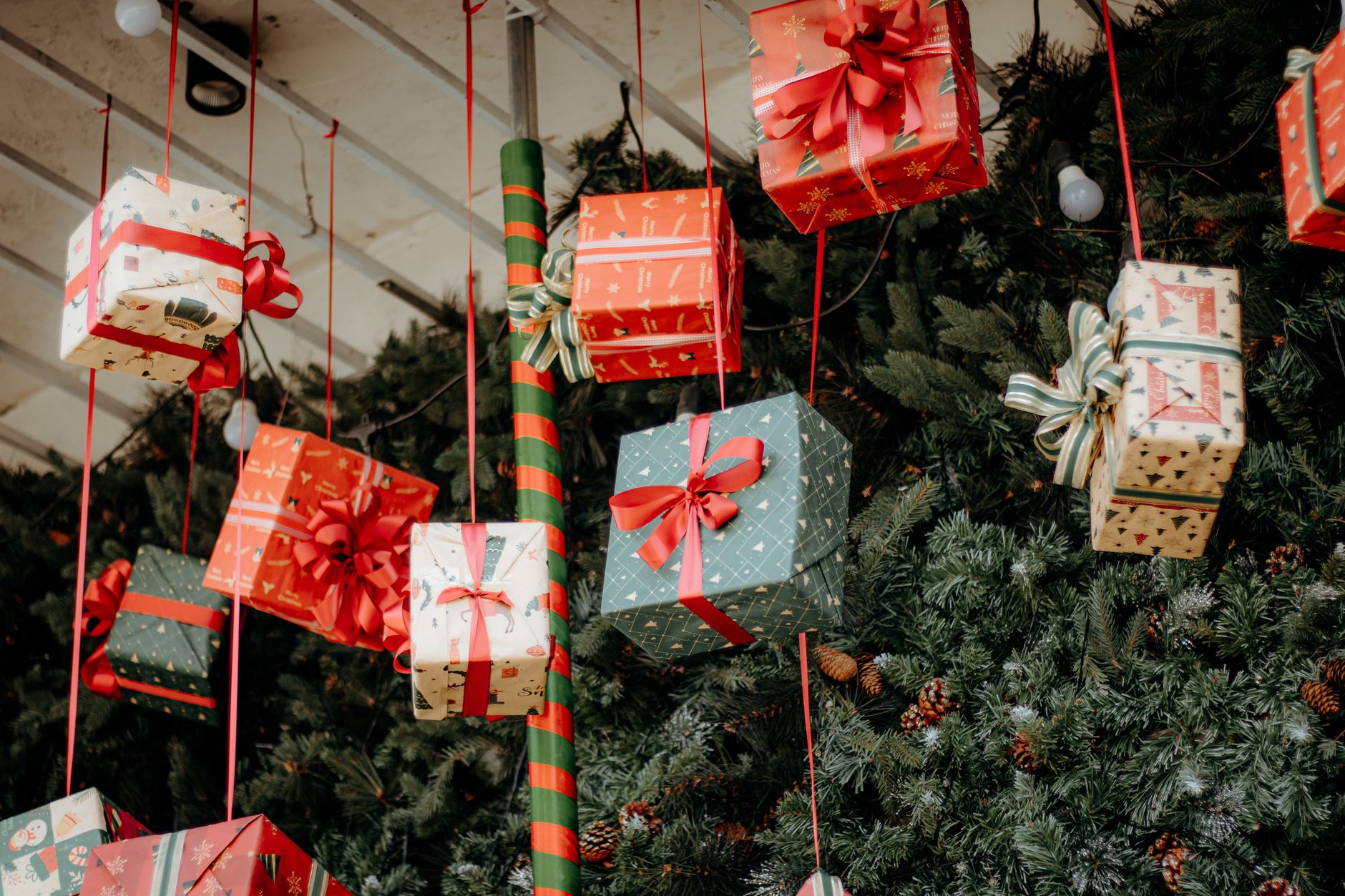 Hanging Christmas gifts with festive decorations and greenery, creating a joyful holiday atmosphere.