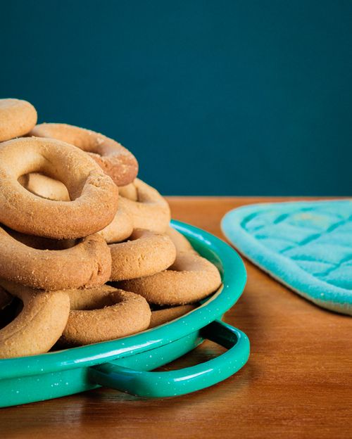 Free A stack of freshly baked donuts on a teal tray, perfect for a cozy snack. Stock Photo
