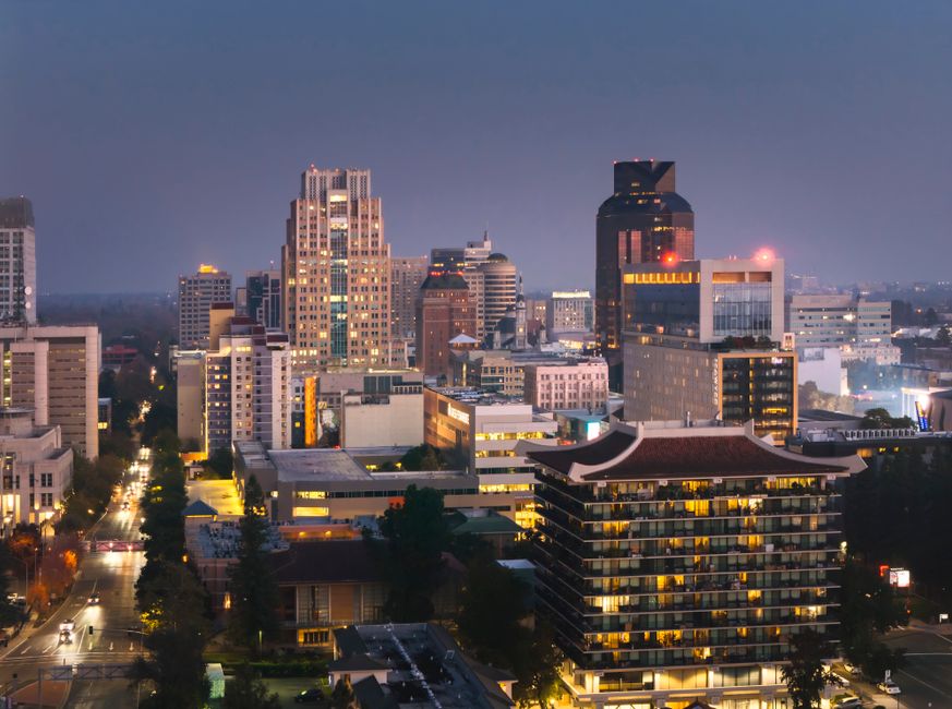 Sacramento city skyline with residential homes in the foreground