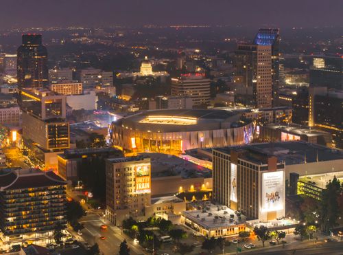 Free Dazzling aerial shot of downtown Sacramento showcasing the Golden 1 Center amid the vibrant cityscape at night. Stock Photo