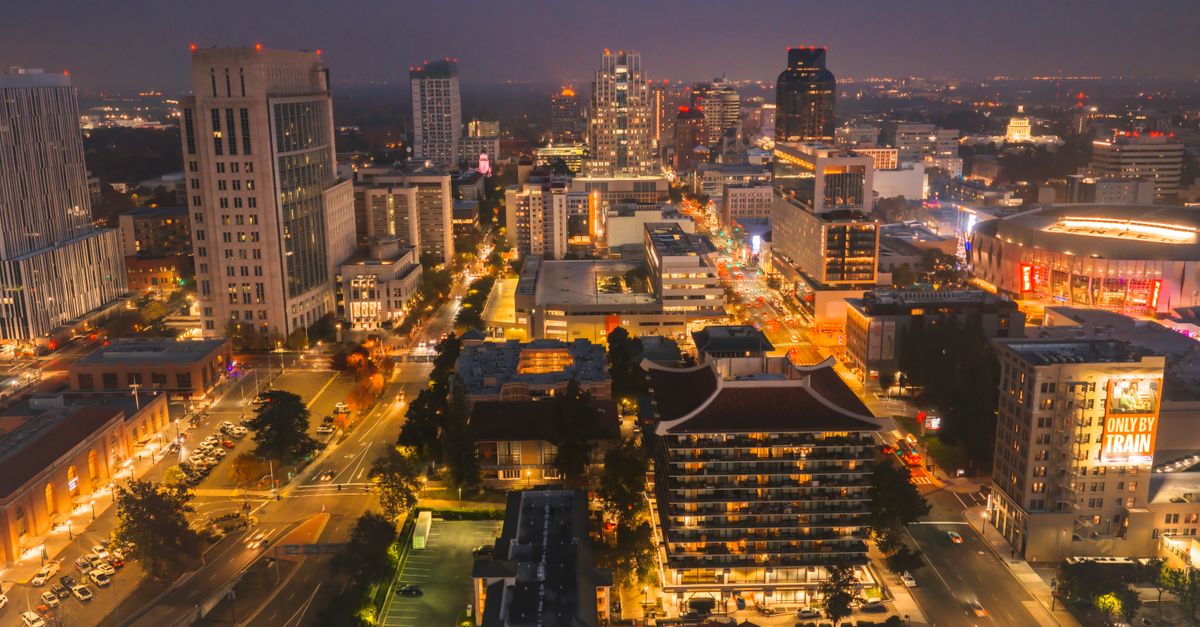 Stunning aerial shot of Sacramento city skyline illuminated at night, showcasing vibrant urban life.