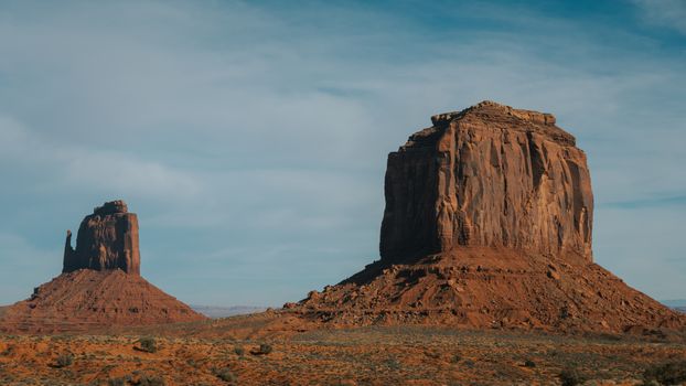 Stunning view of iconic buttes at Monument Valley, Arizona under a clear sky.