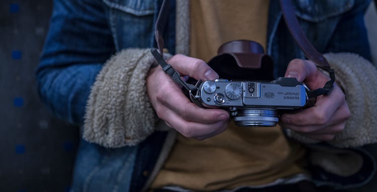 Close-up Photography Of Person Holding Camera