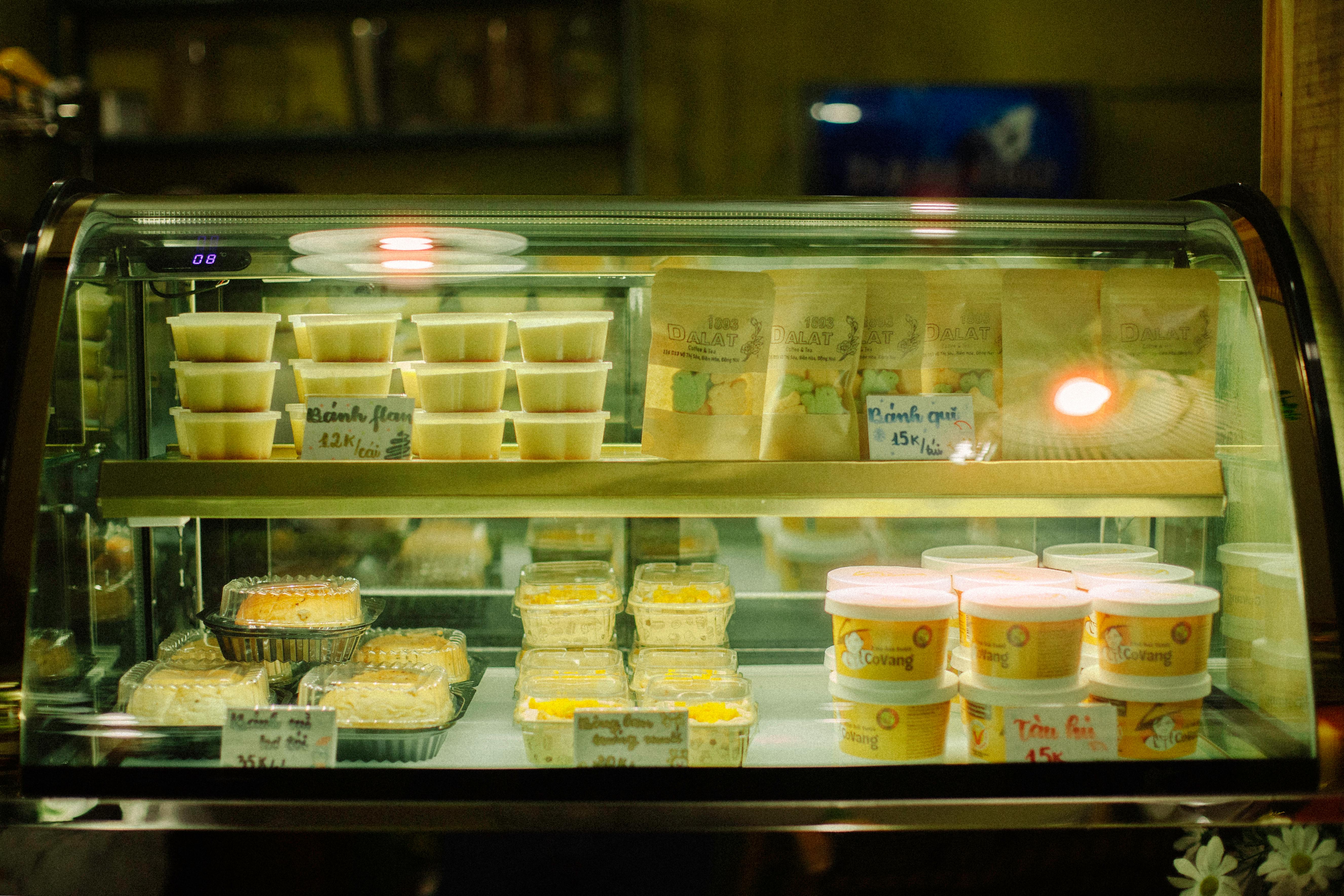 A glowing bakery display case filled with various sweet treats and packaged goods.