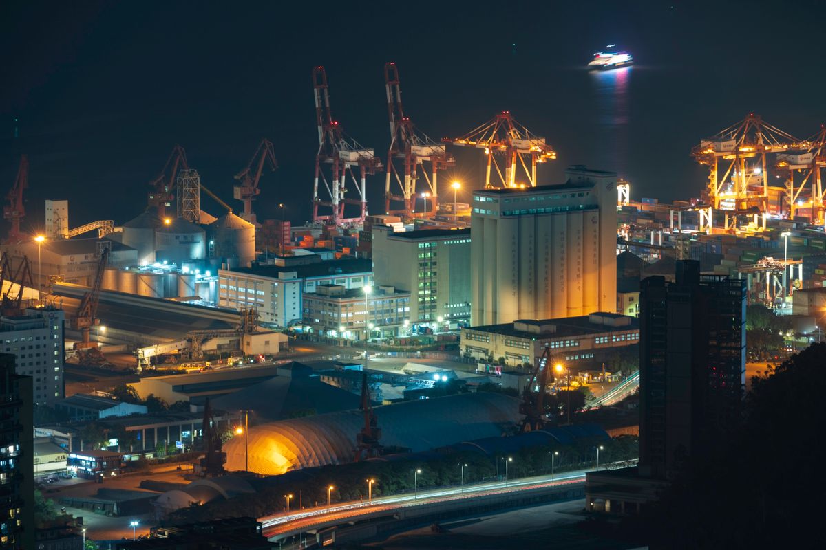 Illuminated industrial port and heavy plant area at night, showing the scale of lighting needed for round-the-clock industrial work