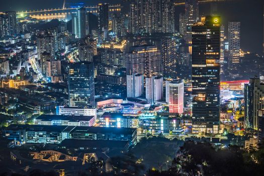 Vibrant city skyline at night showcasing illuminated skyscrapers and urban lights.
