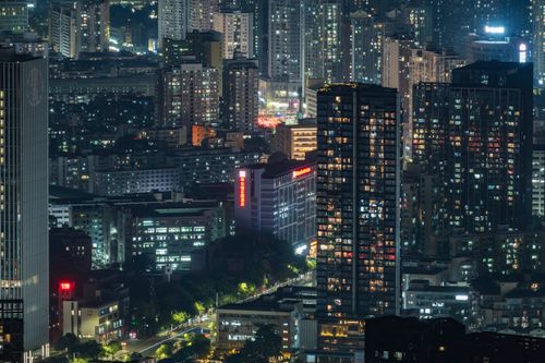 Free Vibrant city skyline illuminated at night with towering skyscrapers. Stock Photo