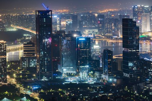 Free Vibrant city skyline at night showcasing illuminated skyscrapers and bustling city lights. Stock Photo