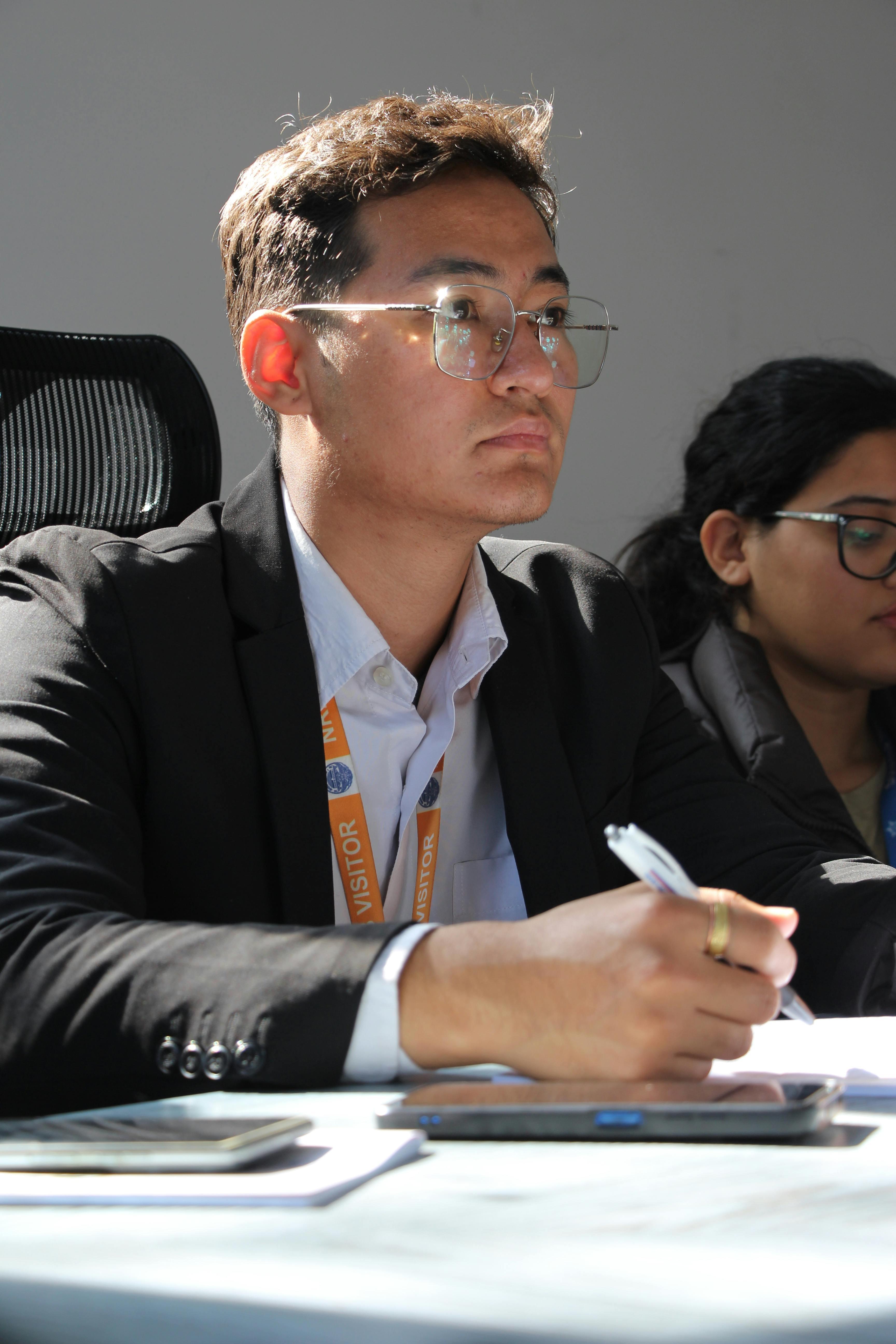 Professor addressing a group of university students in a lecture hall