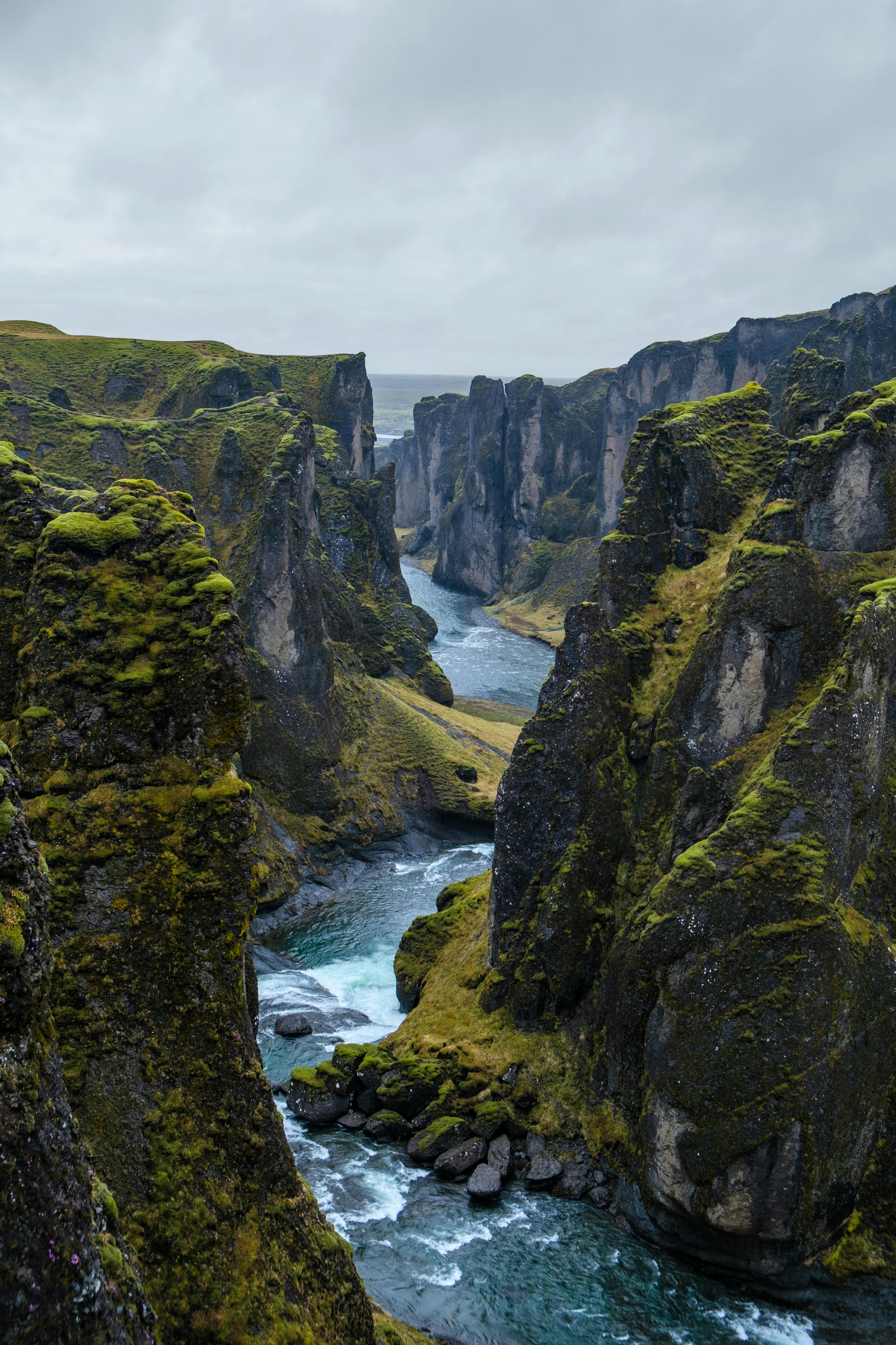 Explore the stunning aerial view of Fjadrargljufur Canyon in Iceland, showcasing rugged cliffs and winding river.